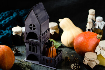 wooden house with tea bags inside around pumpkins and cookies. Glows pumpkin with cutouts, garlands