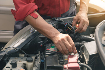 Mechanic repairs car in a car repair station