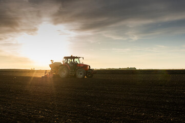 Fototapeta premium Farmer with tractor seeding