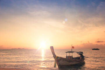 Sunrise sky background concept: Traditional Thai long tail boat at beautiful sunrise background