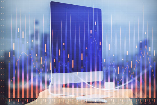 Financial graph colorful drawing and table with computer on background. Multi exposure. Concept of international markets.