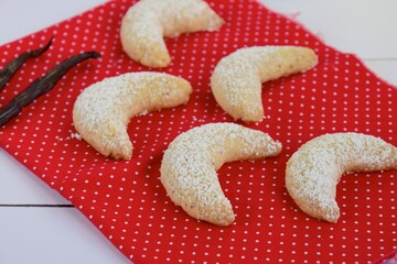 Freshly baked festive German crescent cookies or Vanille Kipferl sprinkled with icing sugar