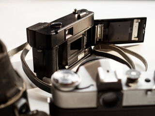 Two vintage film cameras on a light background