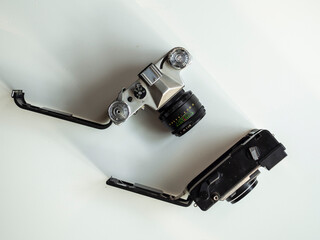Two vintage film cameras on a light background