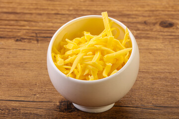 Shredded yellow cheese in the bowl