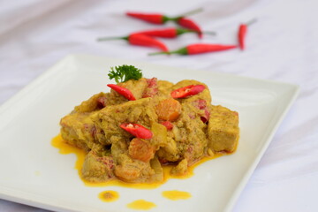 Spicy tempeh curry with carrot cooked in coconut milk and spices