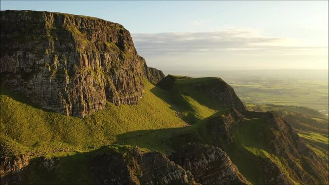 The majestic Binevenagh mountain located near Limavady on the north coast of N. Ireland during golden hour via drone