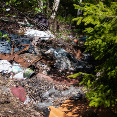 Pile of garage on green grass in the nature environment problems. Nature protection.