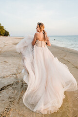 Fototapeta na wymiar bride in dress on beach