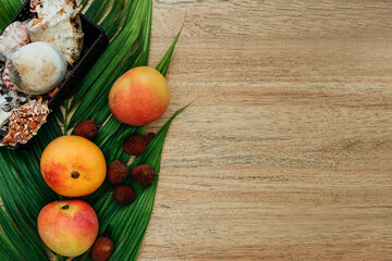Flat lay, top view, Mix of Exotic fruits on a brown background: mangoes, lychee, fruits. healthy diet. Vegetarianism