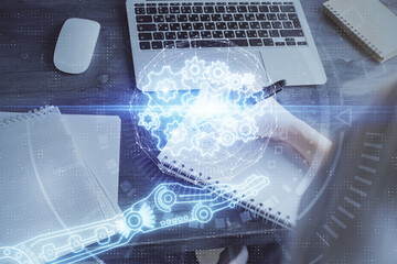 Multi exposure of writing hands on background with data solution hologram. Technology concept.