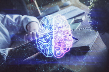 Multi exposure of writing hand on background with brain hologram. Concept of self learning.