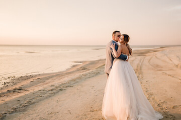 Fototapeta na wymiar bride and groom on the beach