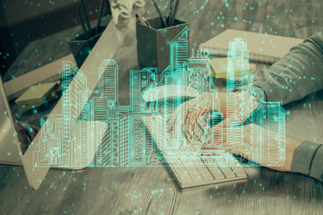 High tech city drawing with businessman working on computer on background. Smartcity concept. Double exposure.