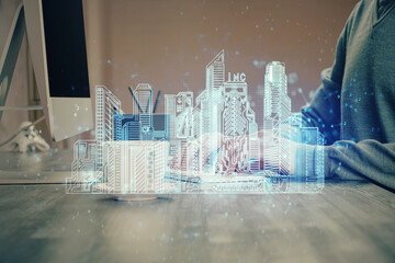 High tech city drawing with businessman working on computer on background. Smartcity concept. Double exposure.