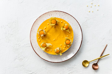 Pumpkin cake decorated with physalis on a white table. Sugar, lactose, gluten free. Horizontal orientation, top view.