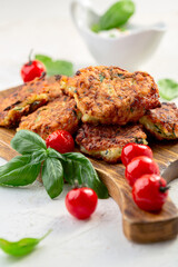 Zucchini pancakes or fritters with caramelized tomatoes.