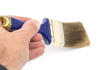 Male hand using blue clean paintbrush isolated on white background.