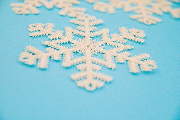 Christmas or winter composition. Pattern of white snowflakes on a blue background. The concept of Christmas, winter, New year.