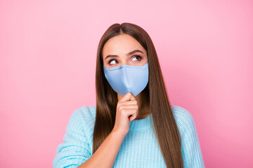 Photo of lady dreamer look up empty space hand on chin wear mask knitted blue sweater isolated pastel pink color background