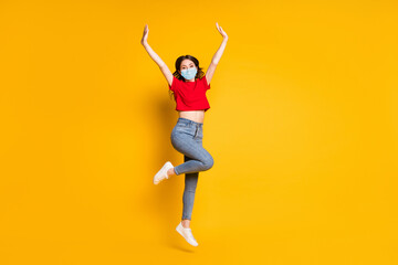 Fototapeta na wymiar Full size photo of lovely pretty girl jump raise hands wear mask isolated over shine color background