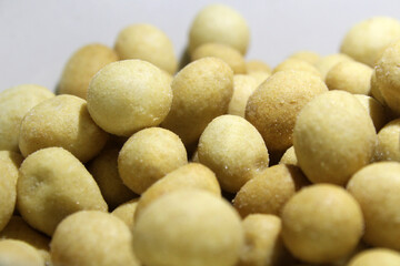 Fototapeta na wymiar Close up savory and crunchy coated nut snacks on white background