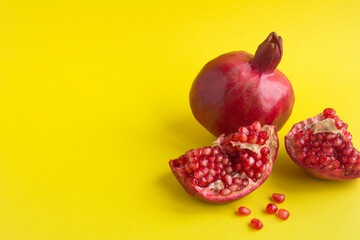 Pomegranate on the yellow background with copy space