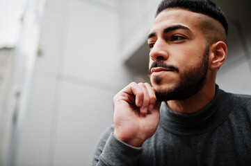 Portrait of stylish arab beard man wear grey turtleneck. Arabian model guy against steel wall.