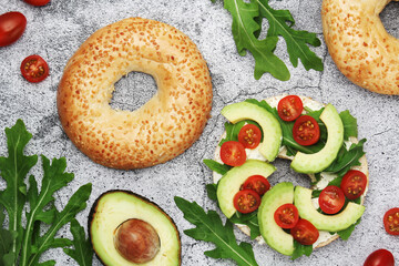 Sesame bagels with tomatoes and avocado