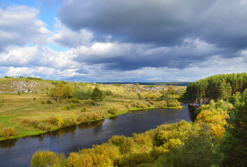 Fototapeta na wymiar Picturesque landscape. The Rezh River in the green banks. Middle Urals. Russia. Russian nature. Autumn Ural.