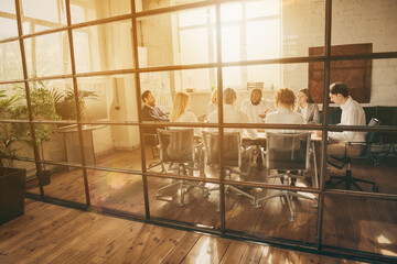 Nice attractive skilled smart clever stylish coworkers specialist shark sales agent broker consulting discussing income money investment growth behind glass wall at modern work place station indoors