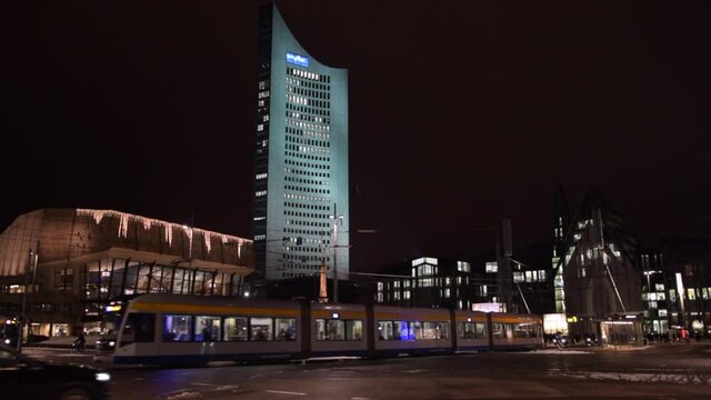 SLOW MOTION: Leipzig MDR Building at Night with Tram passing Traffic, Leipzig, Germany 