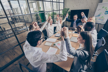 Nice stylish cheerful cheery managers staff gathering holding hands handshake motivation team...