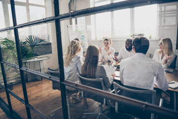 Photo of group smart people marketers investors sit table analyze way-out crisis strategy tell talk say speak solution wear formal outfit in boardroom workplace workstation