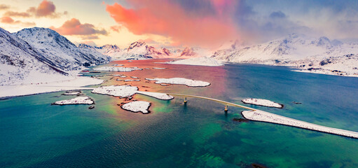 Panoramic morning view from flying drone of Fredvang bridge. Colorful sunrise on Lofoten Islands...