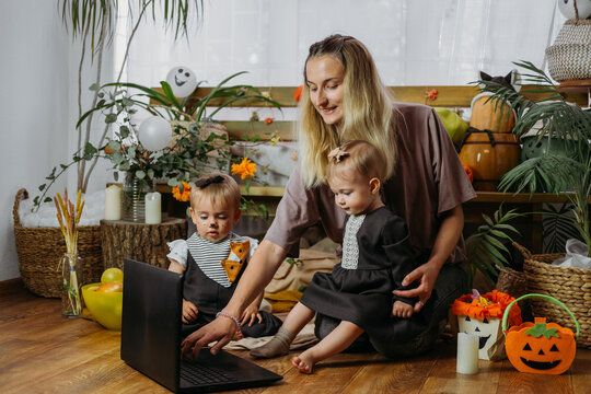 Holidays In The Time Of COVID. Happy Family, Mother And Baby Celebrating Halloween Via Internet In New Normal, Pandemic Time. Online Holiday Party Concept