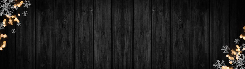 Festive decorative Christmas / Advent background banner panorama template - Bokeh lights and ice crystals, isolated on dark black rustic wooden boards wall texture, with space for text