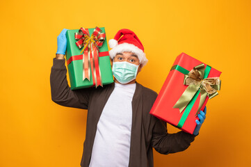 Delivery man in christmas uniform carrying many gift box to send