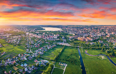 Fototapeta premium View from flying drone of Ternopil city. Astonishing summer sunrise on Seret river. Beautiful morning cityscape of Ternopil, Ukraine. Traveling concept background...