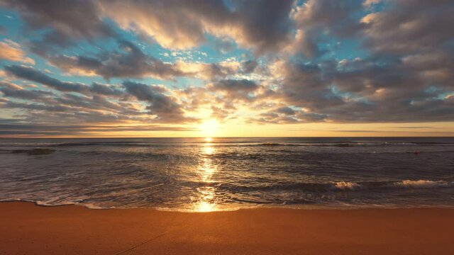 Ocean beach sunrise 4k video, waves splash on the sea sand

