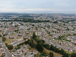 aerial view of housing estate with modern houses and flats looking towards Poole Harbour in the...