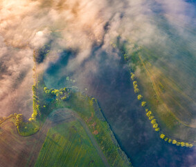 Straight down view from flying drone of Angelivka pond. Foggy morning scene of outskirts of Ternopil town, Ukraine, Europe. Beauty of nature concept background. Flying above the clouds on drone... © Andrew Mayovskyy