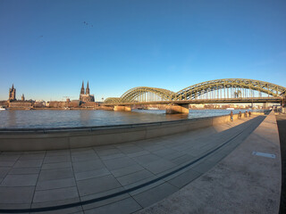 View of Cologne with the Great St. Martin Church, the Cologne Cathedral (Kolner Dom) and Hohenzollern Bridge from bank of the Rhine river, Germany.