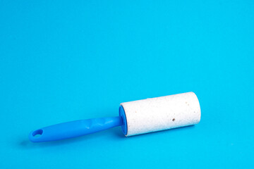 Lint roller for clothes on blue dirty