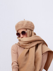 Stylish Details of everyday look.  Model wearing casual beige outfit.  Beret  and scarf. Trendy...