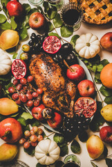 Autumn Thanksgiving, Friendsgiving, family party gathering celebration dinner. Flat-lay of Fall decorated table with roasted duck in seasonal fruits and vegetables, apple pie and drinks in glasses
