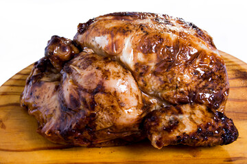 Roast chicken on a wooden tray on white background