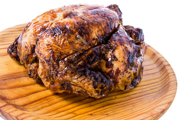 Roast chicken on a wooden tray on white background