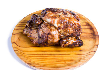 Roast chicken on a wooden tray on white background