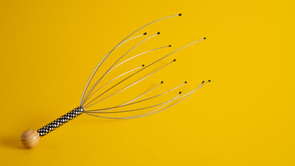Massager for a head in on a yellow background isolation. Home use Acupuncture Point Head Scalp...